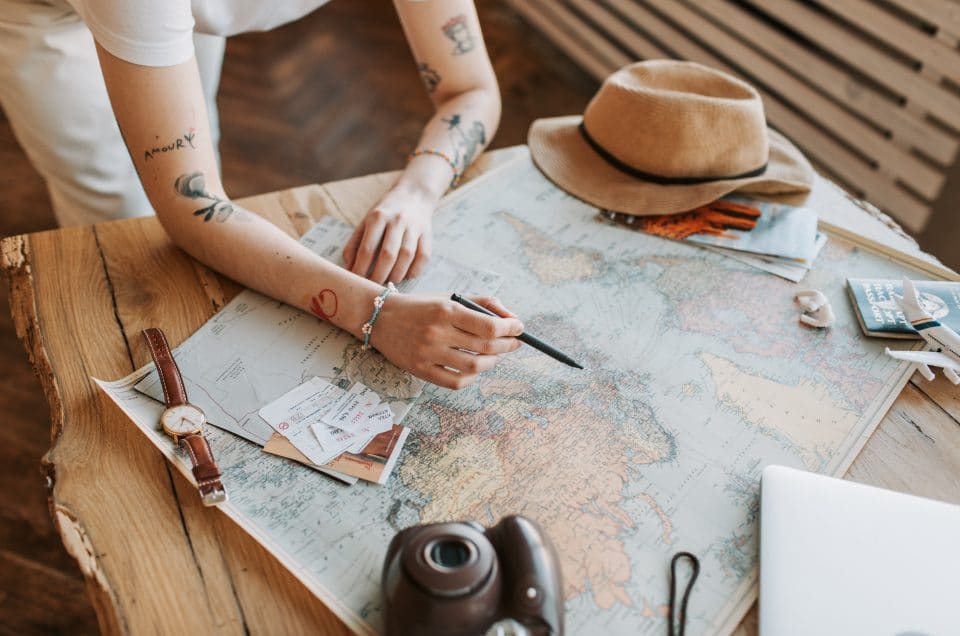 Young woman traveler looking at a map outside